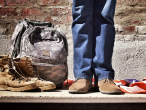 Soldier standing with bag and boots from feet down